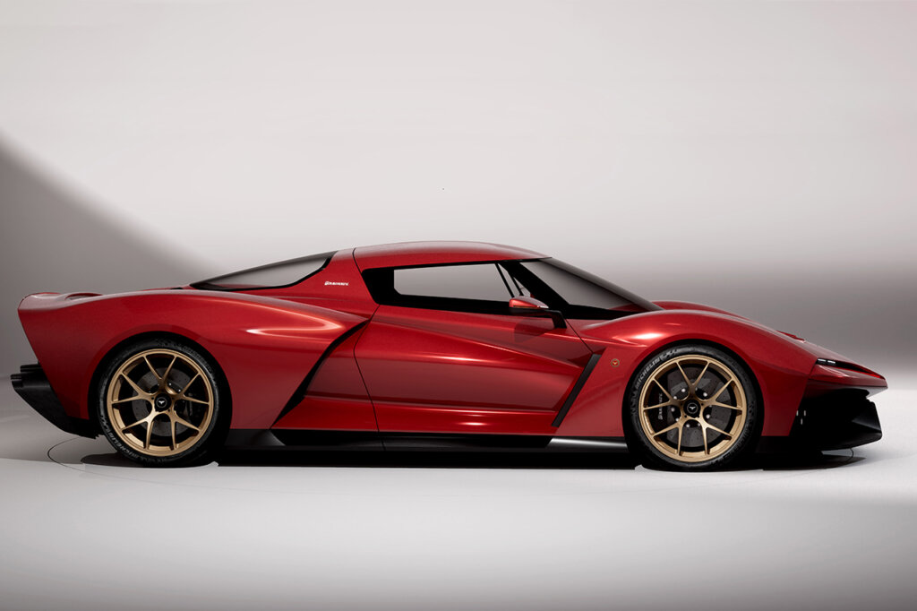 Side profile of the Bizzarrini Giotto with a white wall behind it with a large shadow cast on it