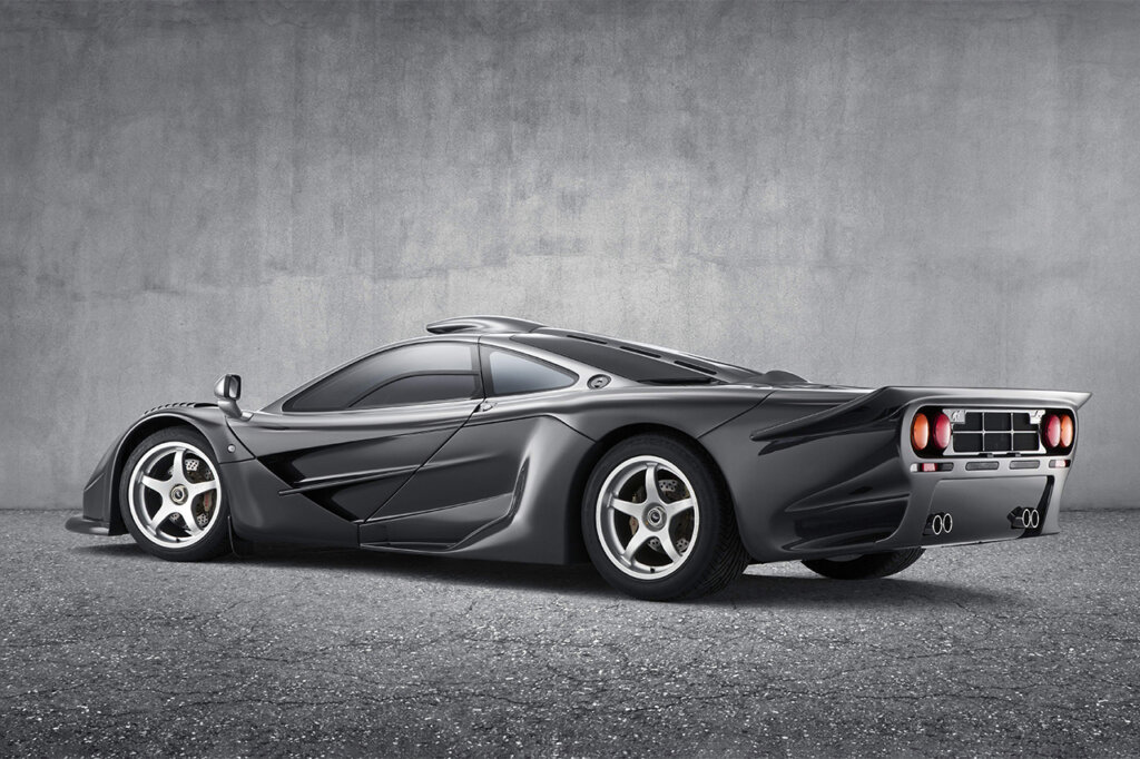 McLaren F1 long tail infront of a concrete wall
