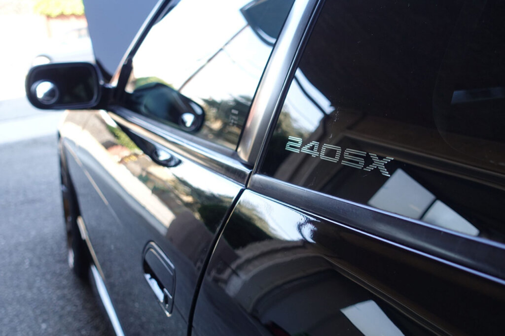 Decal that says 240sx on window of a Nissan S13