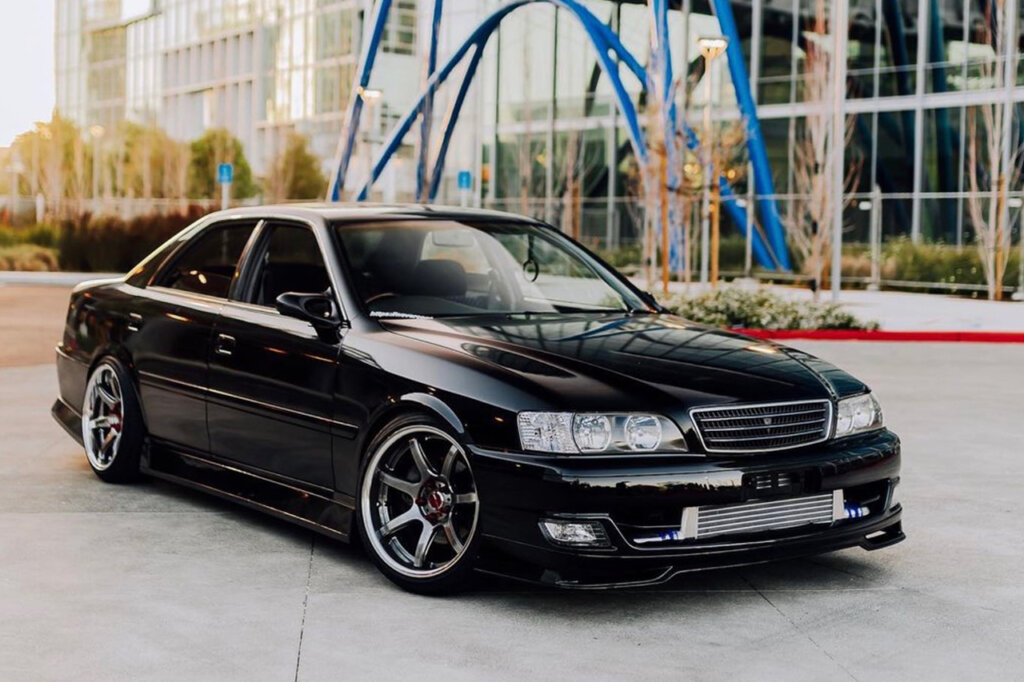 Black Toyota Chaser Tourer V parked in front of a building