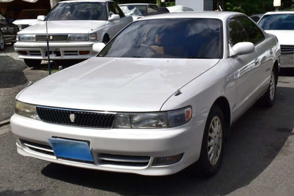 White X90 Toyota Chaser Avante parked in a lot of other cars
