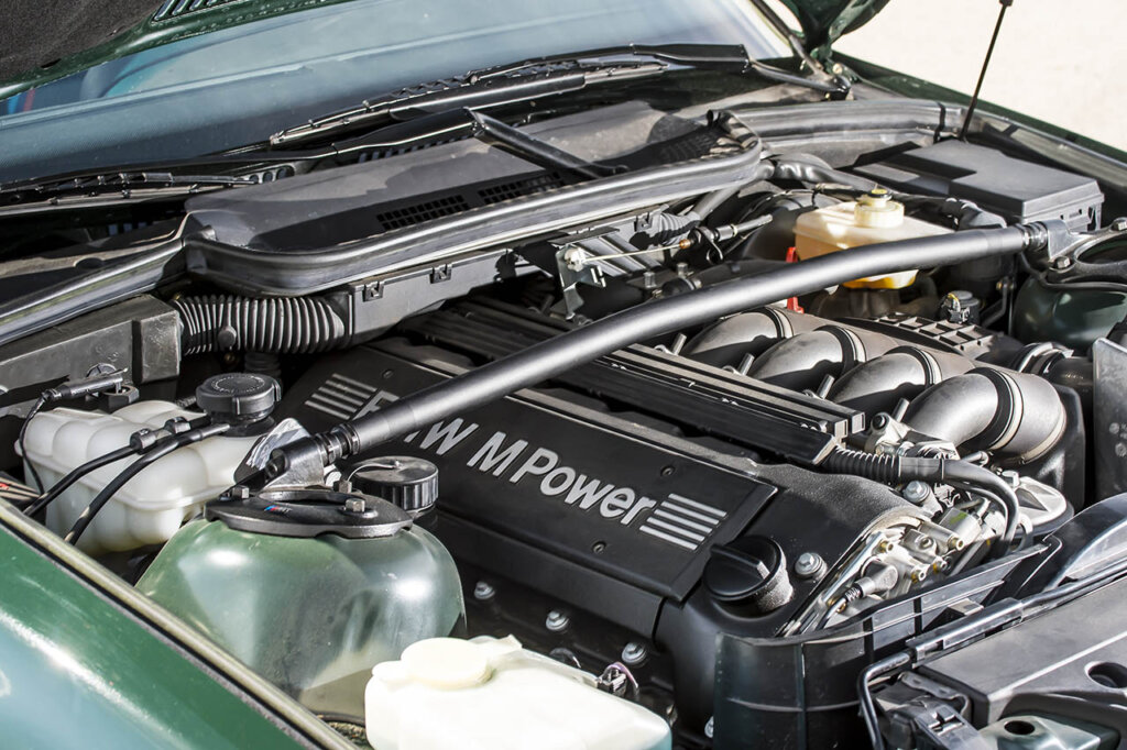 engine of a green bmw m3 e36 gen