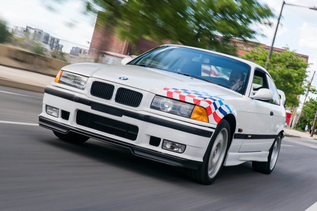 white bmw e36 m3 lightweight model in city street
