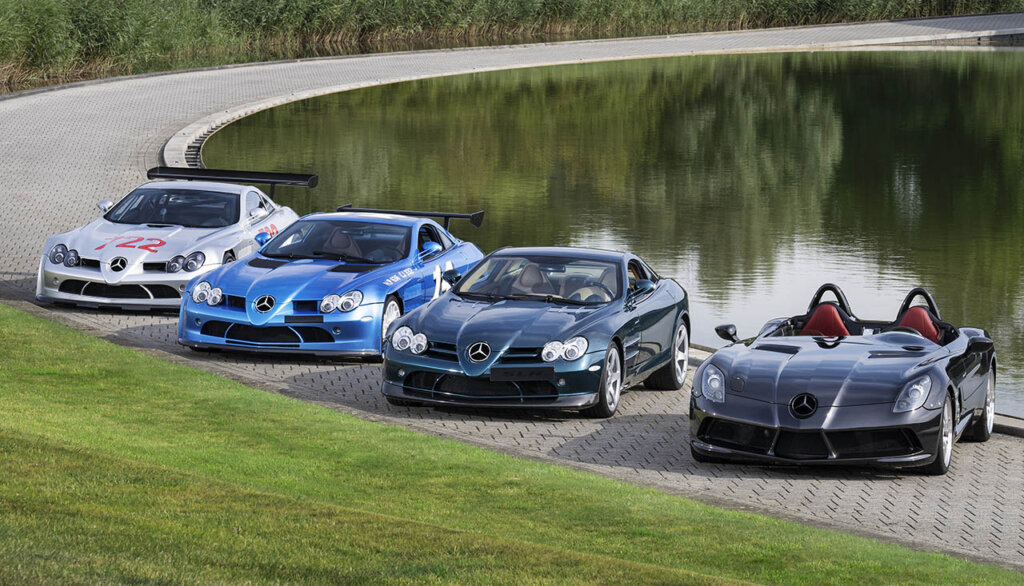 various mercedes slr mclaren models next to a pond