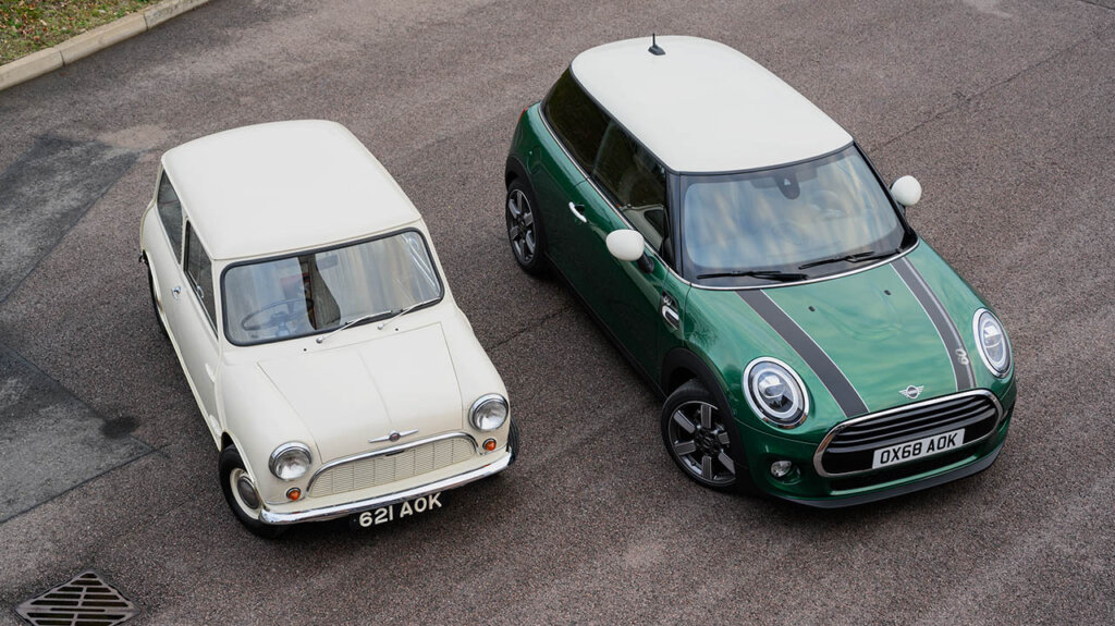 white 1959 morris mini minor and green mini cooper on urban street