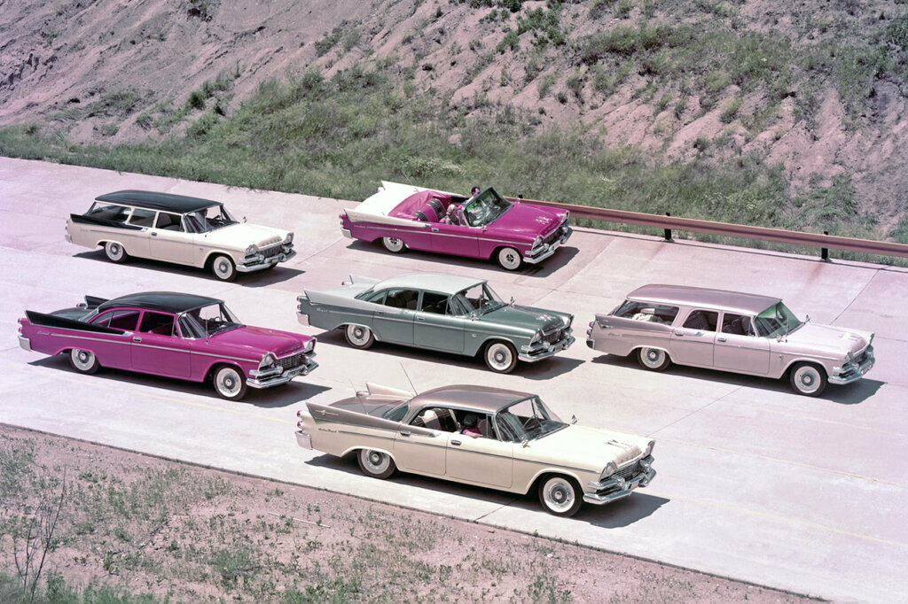 Collection of Dodge cars parked next to one another on a 4 lane roadway