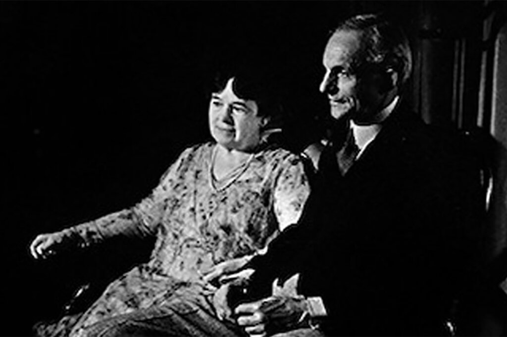 Henry Ford and his wife Clara Ford sitting next to one another in a room