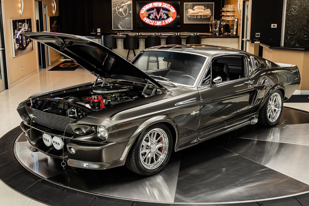 Ford Silver GT500 Mustang parked in a garage on a circular platform