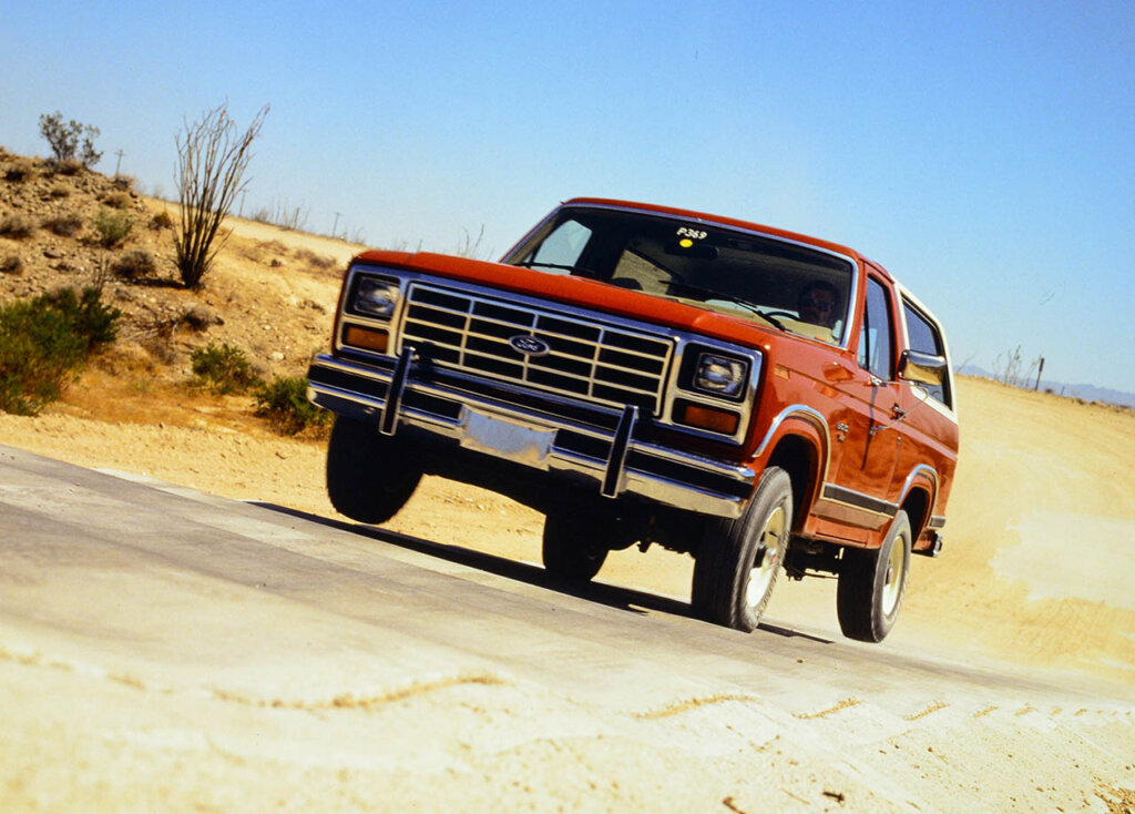 red orange third gen bronco speeding in desert