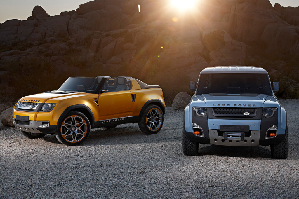 DC100 Concept Land Rover's one yellow and one blue. Mountain blocking the sun in the background