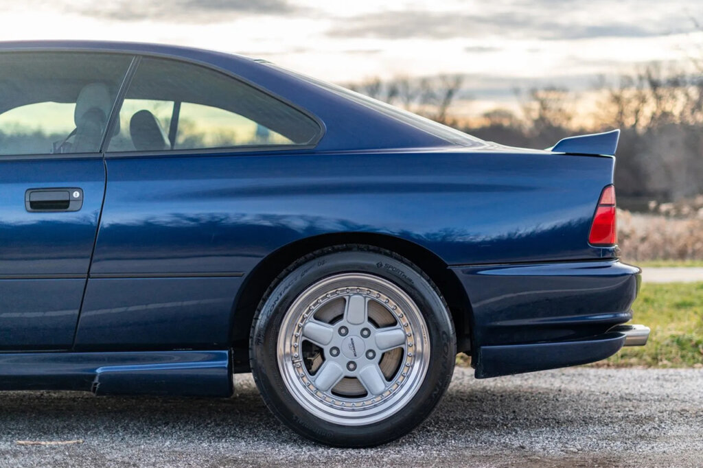 rear quarter panel shot of a blue car with chrome wheel