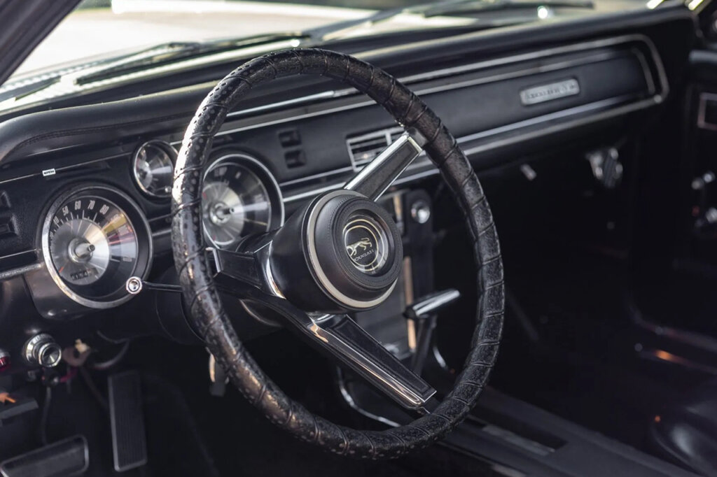 Steering wheel and dash of a Mercury Cougar all black