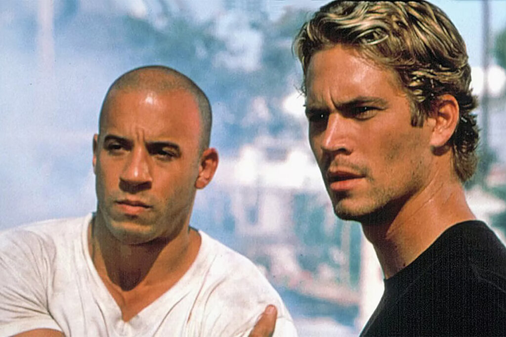 Two men standing next to each other staring off to the left