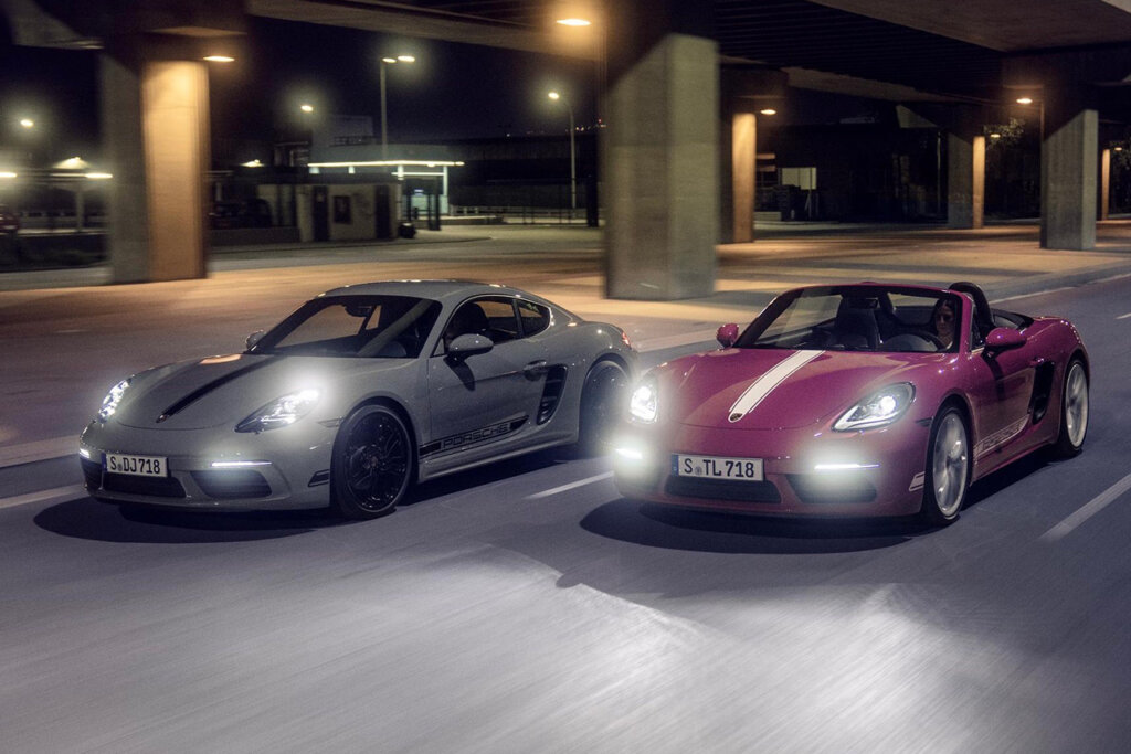 Two vehicles one grey and one purple driving next to one another at night