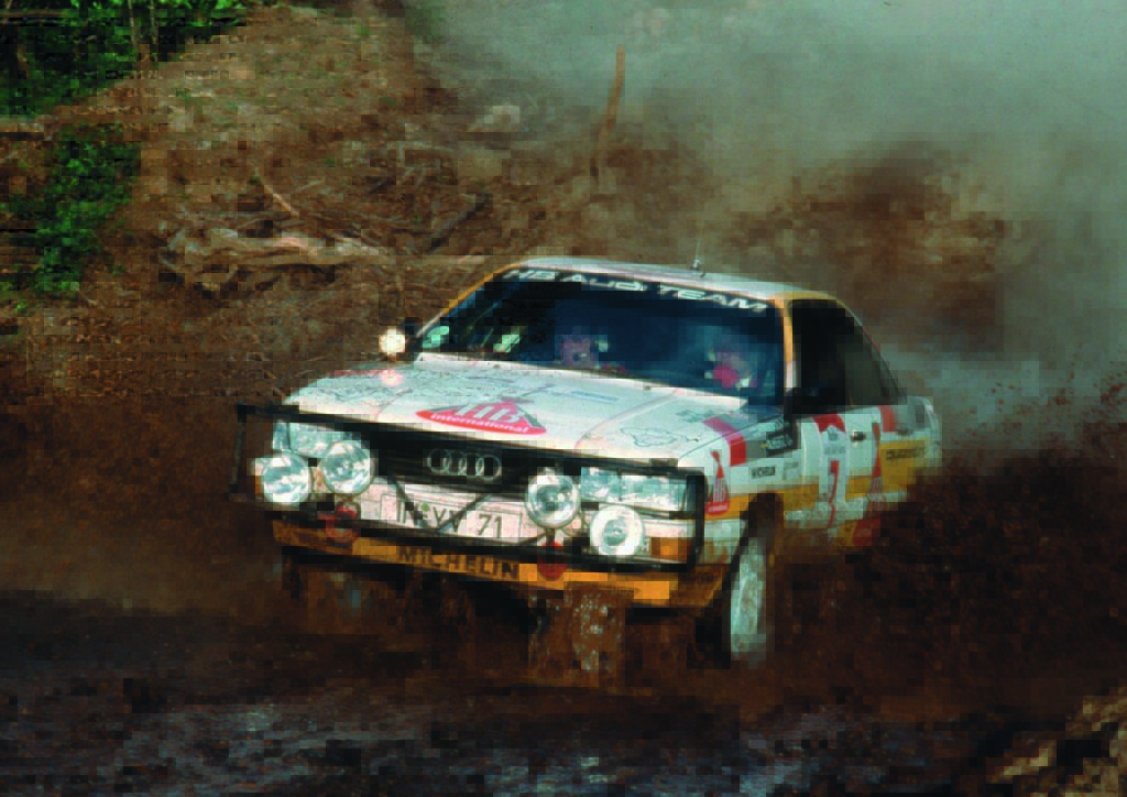 White Audi Quattro splashing mud