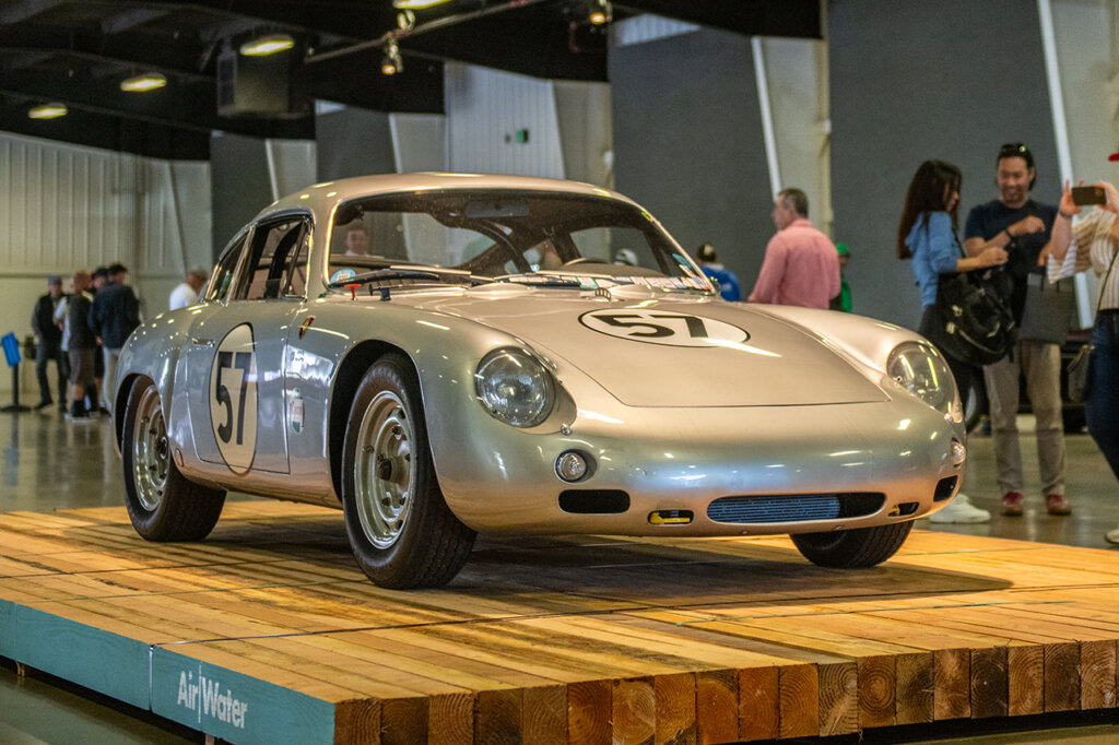 Silver Porsche Abarth GTL 365 parked on a wooden platform that says air - water on the corner
