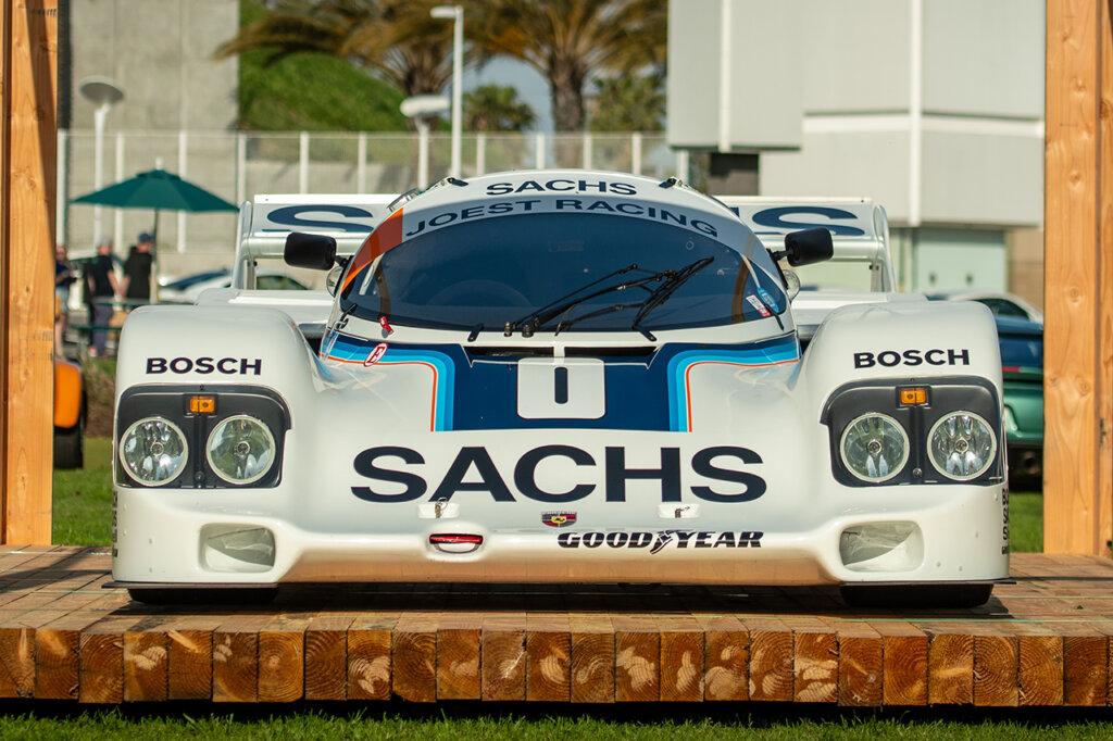 Sachs Porsche 962 Le Mans race car parked on a wooden stage