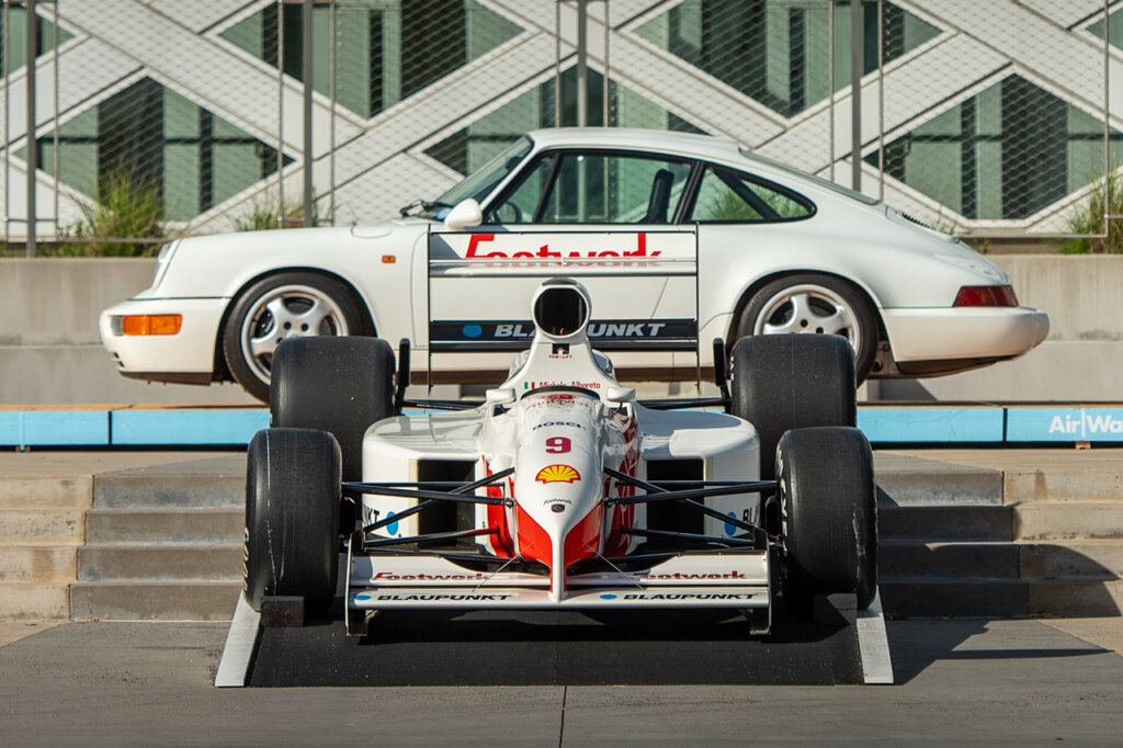 two white cars staged next to one another with a blue stripe going across image