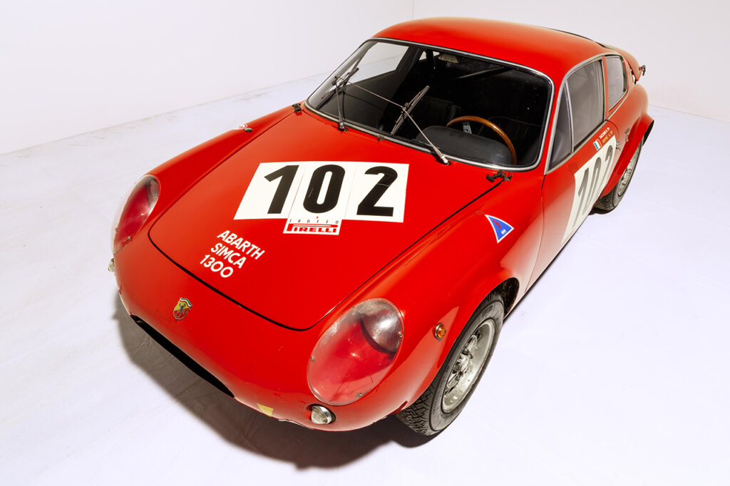 Red Abarth Simca 1300 with the number 102 on its hood