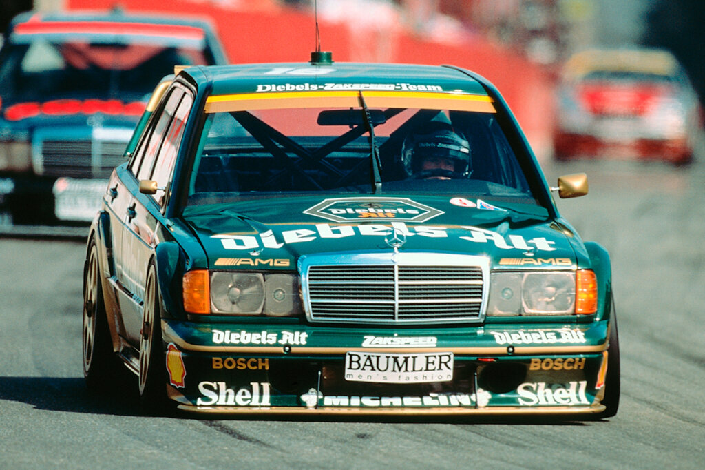 Green Mercedes 190E EVOII race car on a racetrack driving