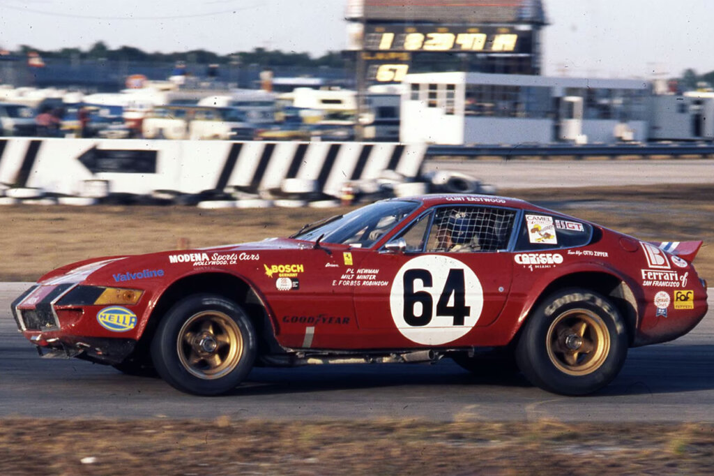 Red Ferrari 365 GTB/4 race car with number 64 on the door