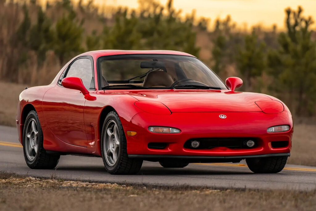Red Mazda Rx7 FD parked with the sunsetting in the background