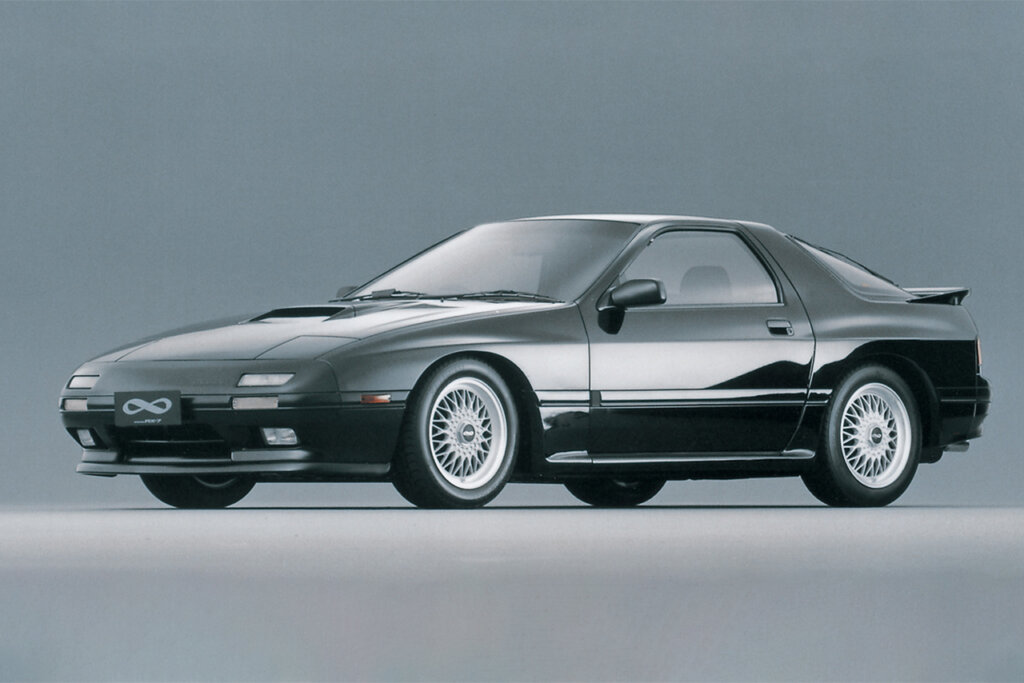 black Mazda rx7 FC on a grey background