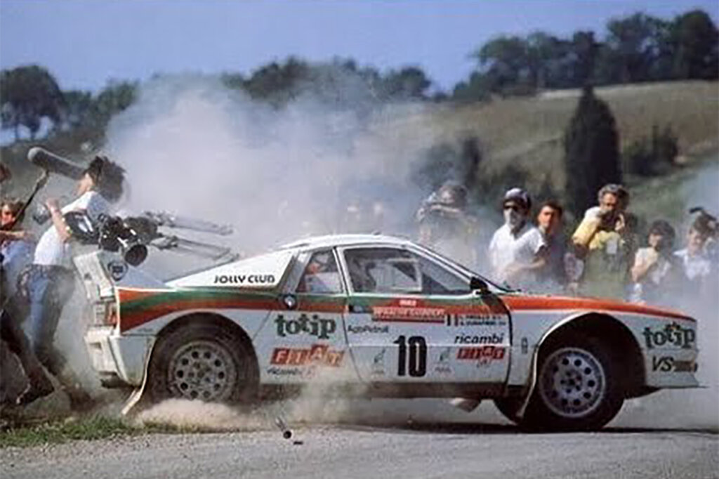 white Group B rally car hitting a spectator