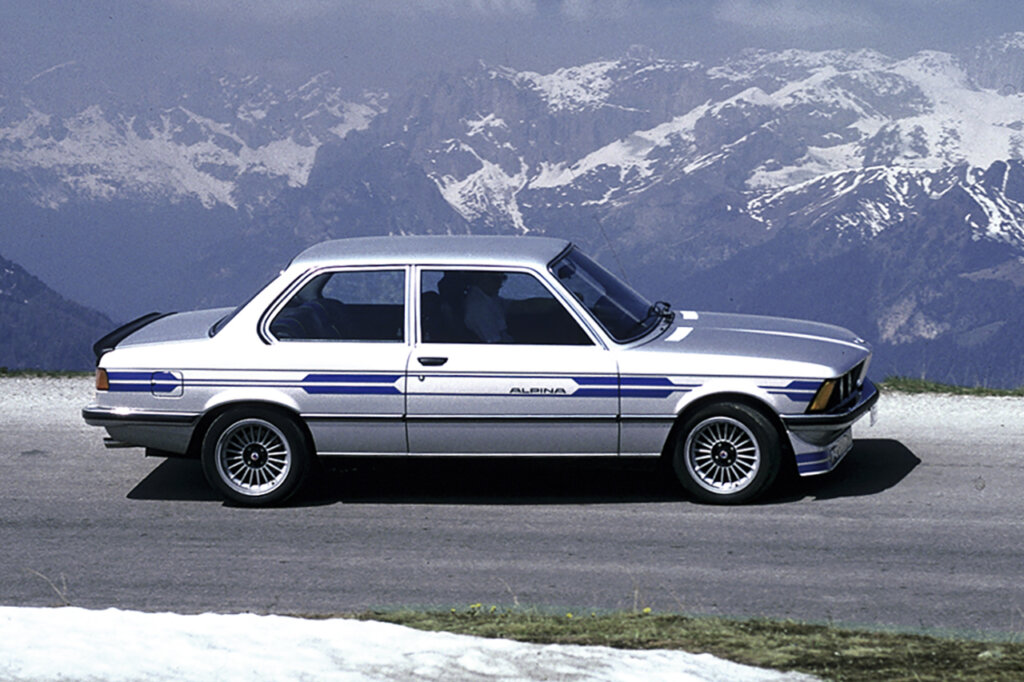 Silver with blue accents BMW Alpina 3-series with snow landscape behind it