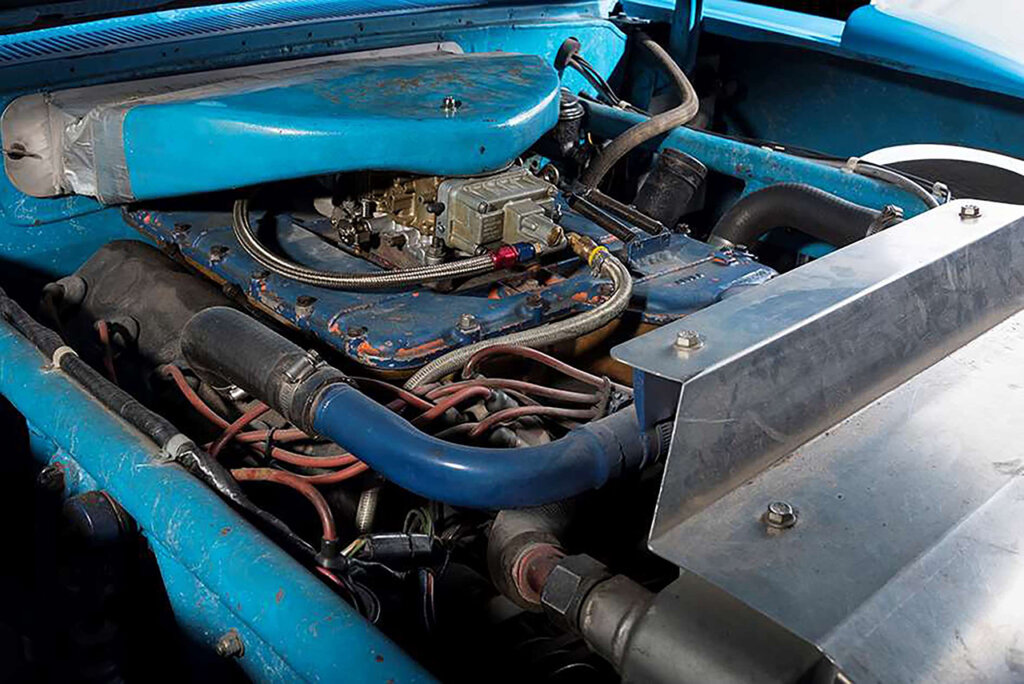 Plymouth Roadrunner racecar engine next to metal sheet