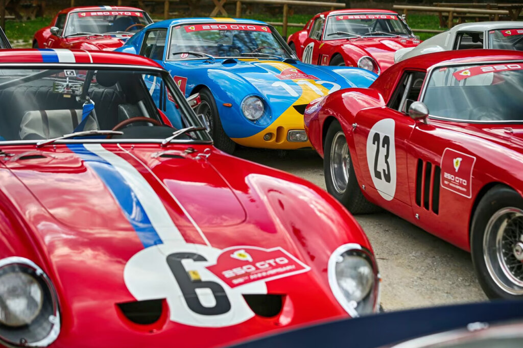 Several Ferrari cars next to eachother, one blue car with red ones