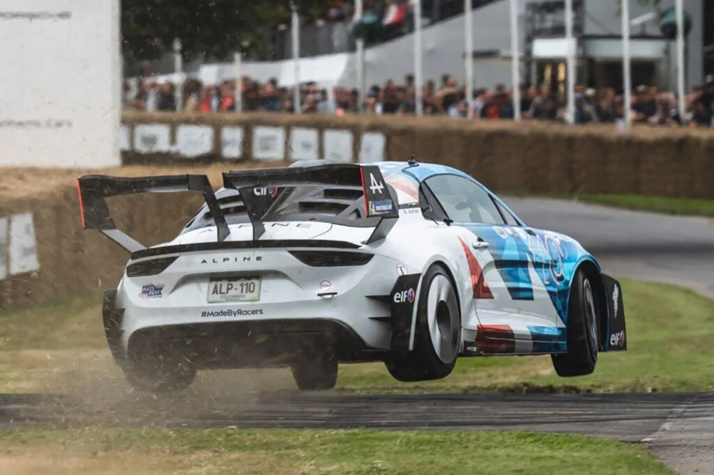 White Alpine A110 Pikes Peak racecar airborne on a racetrack
