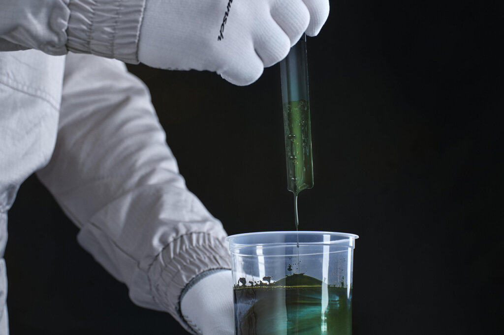 custom green paint being mixed and pulled into syringe with someone wearing white gloves