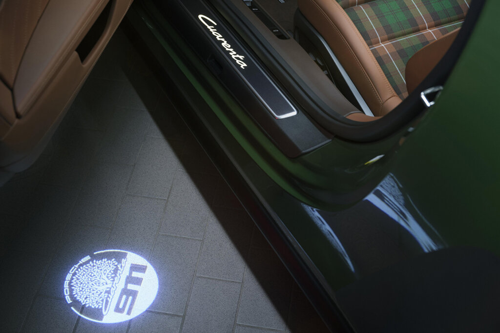 green Porsche 911 car with projected 911 badge from door