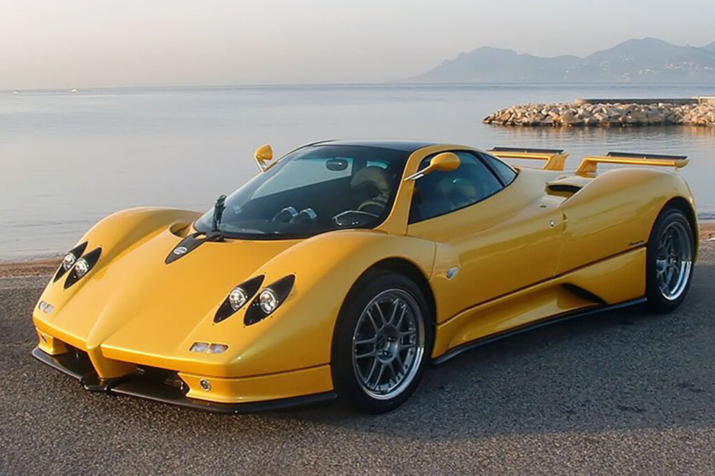Yellow Pagani Zonda overlooking the ocean and mountains in background