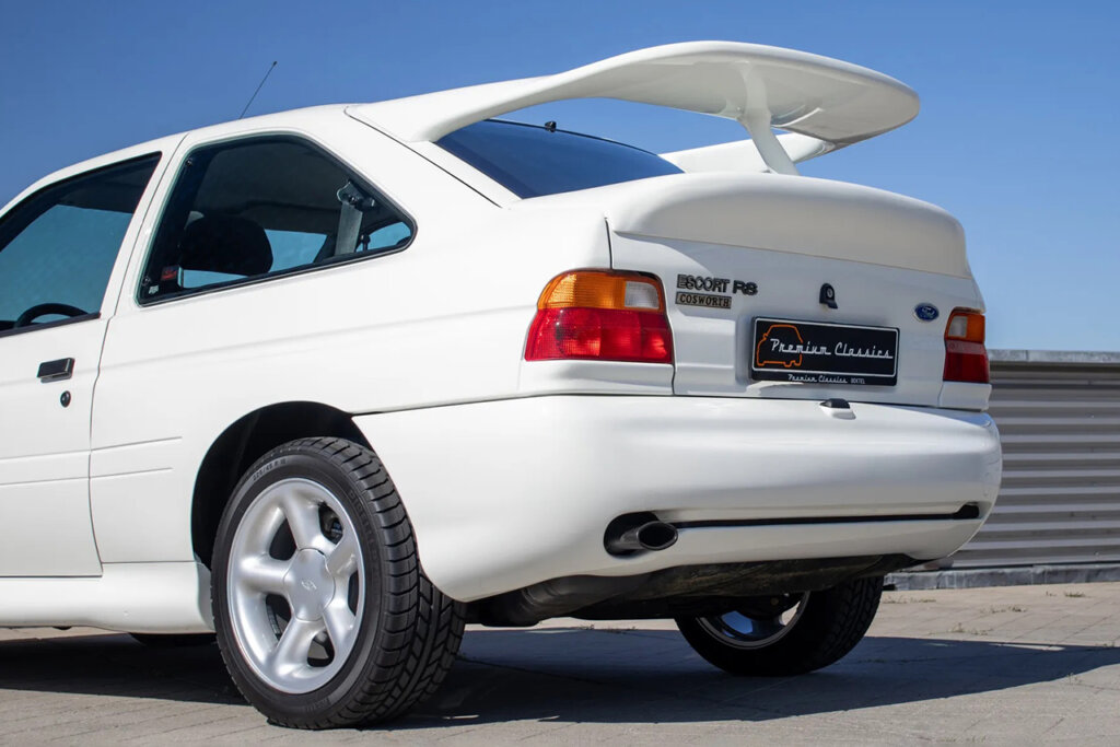 White Ford escort parked with clear blue sky