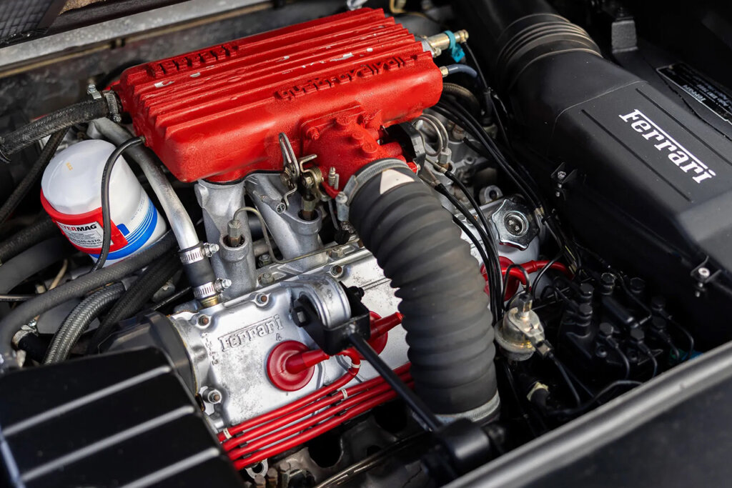 Red valve cover of a Ferrari 308 quattrovalvole engine