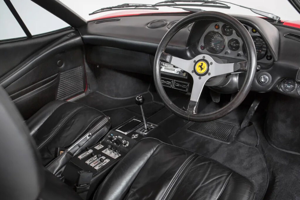 Black interior with Ferrari steering wheel and black leather seats