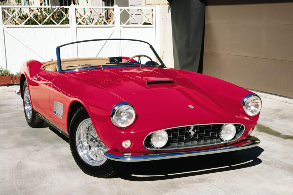 red ferrari 250 gt replica parked in front of a house