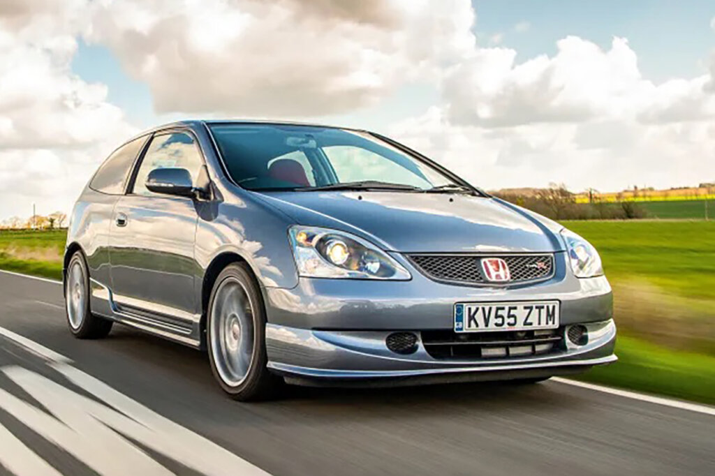 Silver EP9 Civic driving on a road with sky and grass in the background