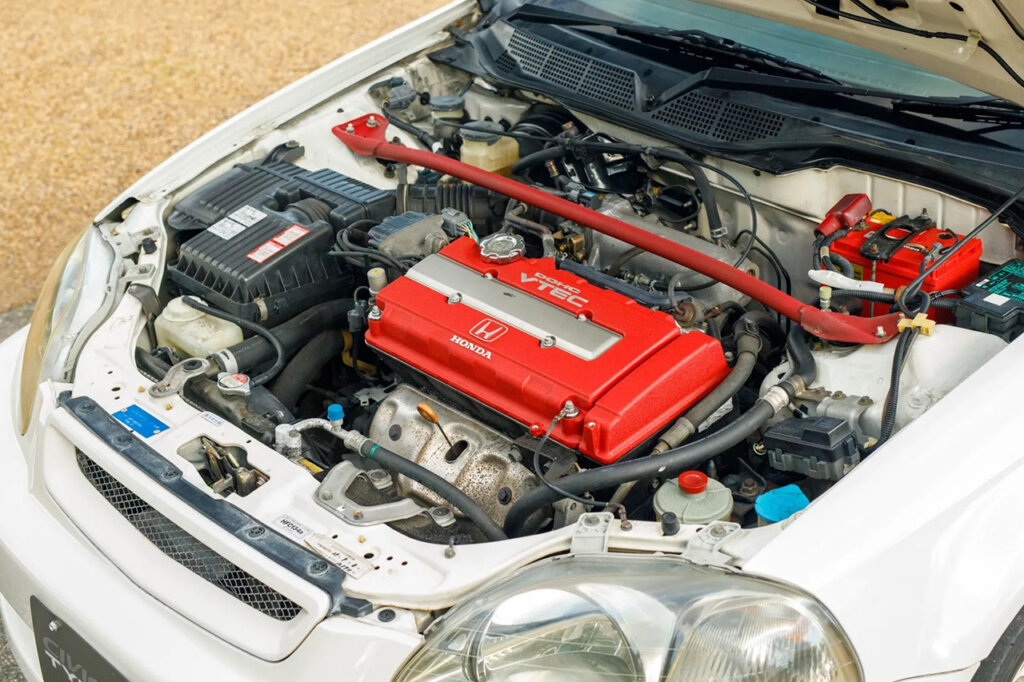 Red valve cover and strut bar of a Type R engine in a white car