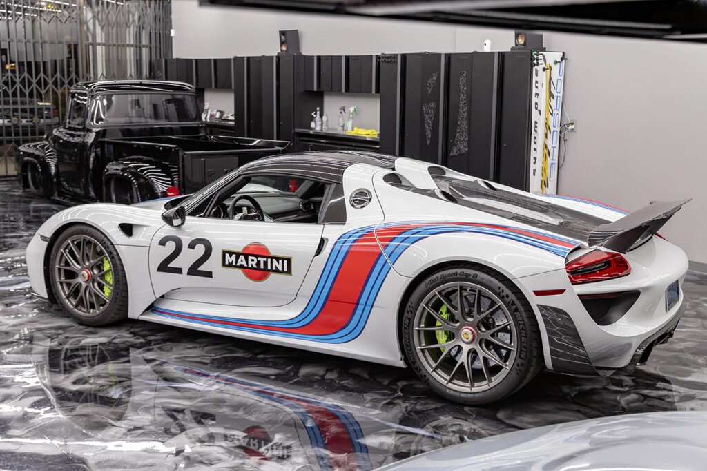 White 918 car in a garage near other cars