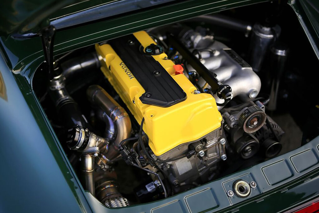 Yellow K24 Honda engine inside of a green Porsche RWB 911 engine bay