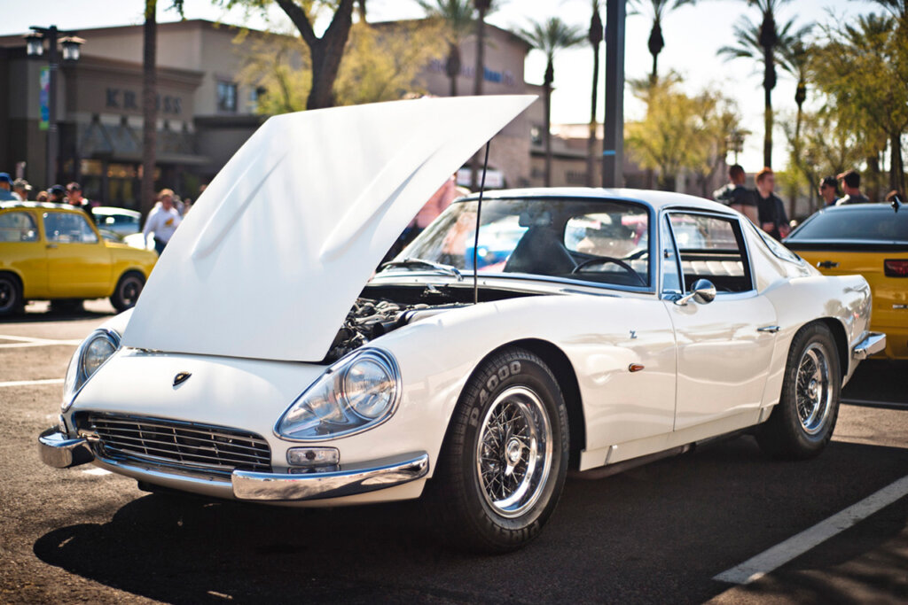 White Lamborghini 3500 GTZ parked in a parking lot with the hood propped open