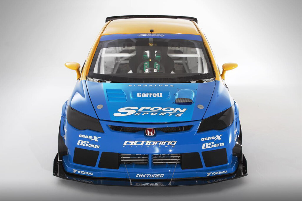 Front end of a Honda civic type R with yellow and blue Spoon livery