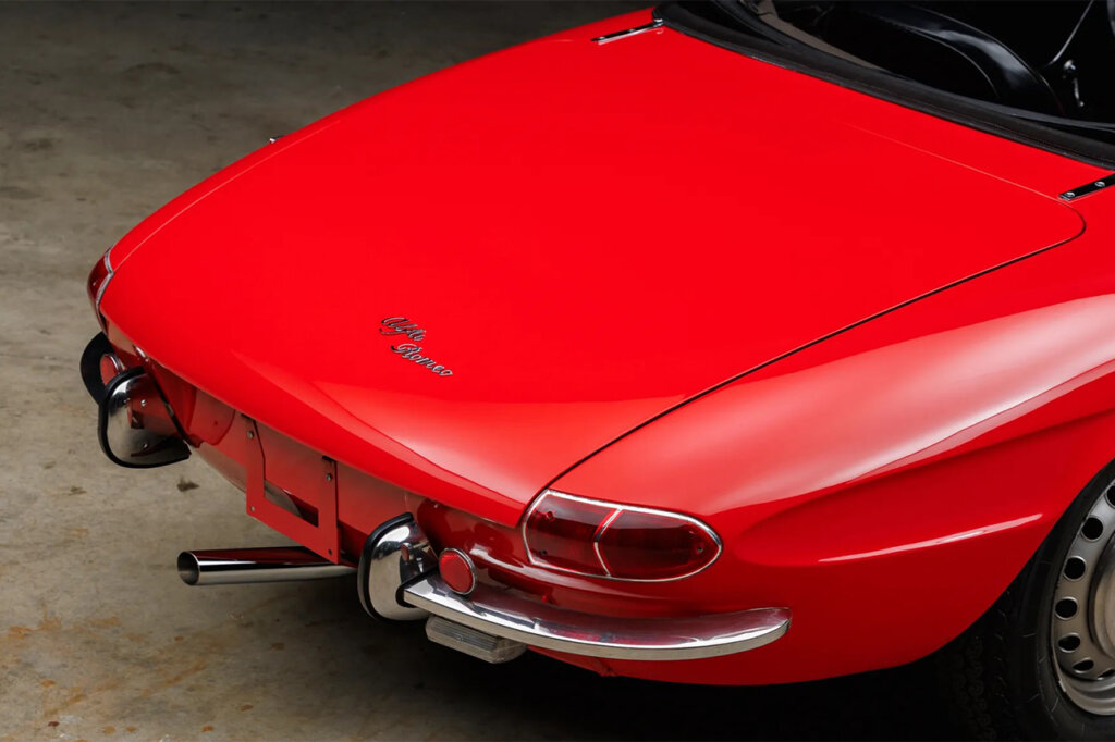 Red Alfa Romeo Duetto rear side with chrome bumper with small red taillights