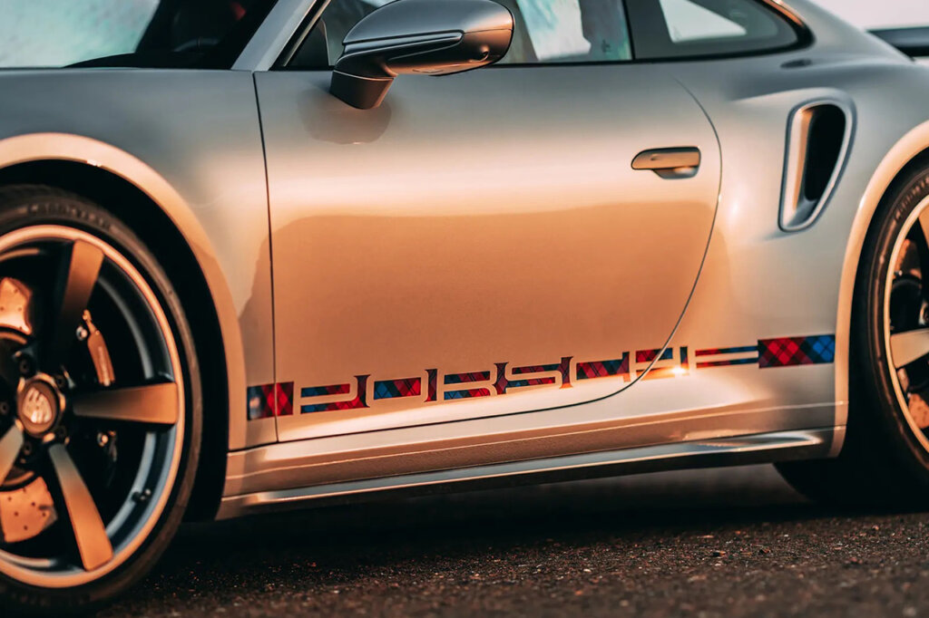 Silver Porsche 911 with plaid design PORSCHE logo on the bottom of the door