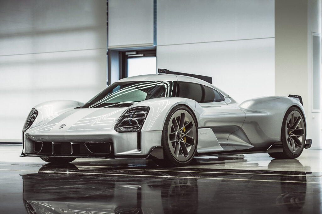 White 919 Street concept car in a showroom floor with large windows behind it with black reflective floors.