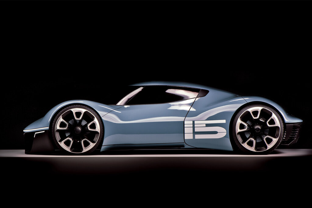 Blue Porsche Vision 916 concept car with the number 15 on the rear quarter under a spotlight with a solid black background.