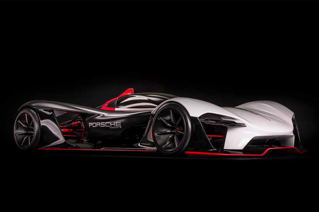 Black and white with red accents of a Porsche Vision E concept car pictured on a black background.
